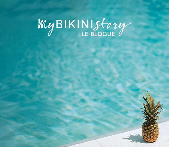 Ananas pos&eacute; sur le bord d'une piscine. 