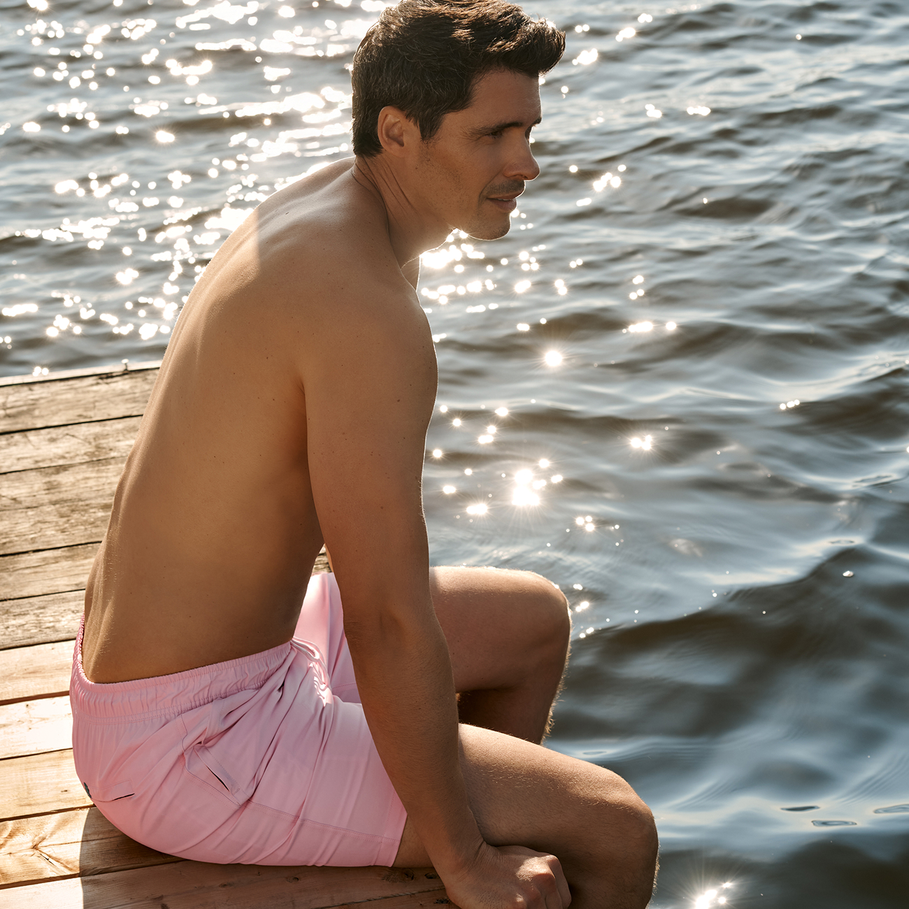 A man wearing a pink swimsuit from Shoreline Seven – Bikini Village